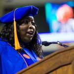 Sanethia Thomas speaks during the college recognition ceremony