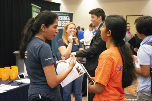 A student talks with a representative from Gartner.