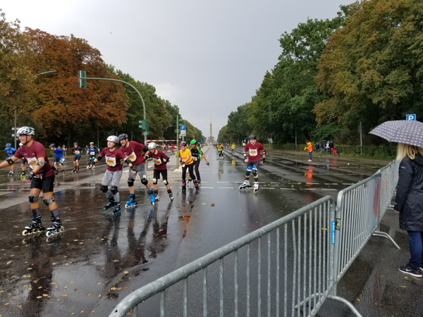 A view of Berlin's Siegessaule with rollerbladers in the foreground.